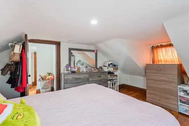 bedroom with lofted ceiling, recessed lighting, and wood finished floors