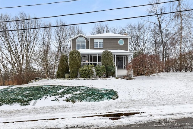 view of front of property featuring a porch and a chimney