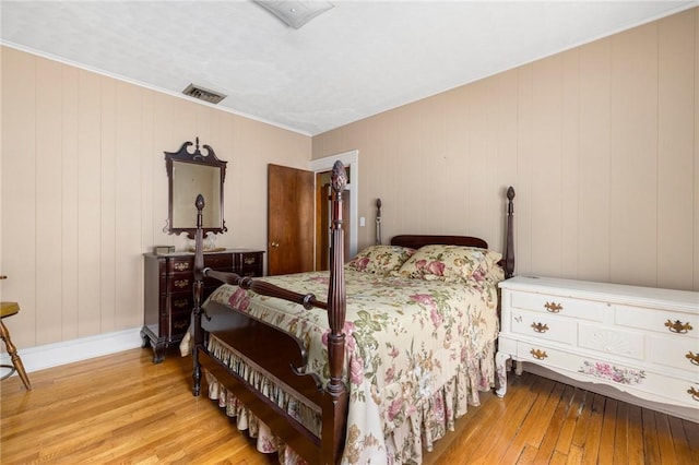 bedroom featuring baseboards, visible vents, and hardwood / wood-style floors