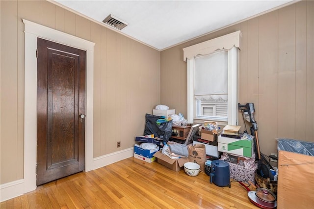 bedroom with visible vents, hardwood / wood-style flooring, and baseboards