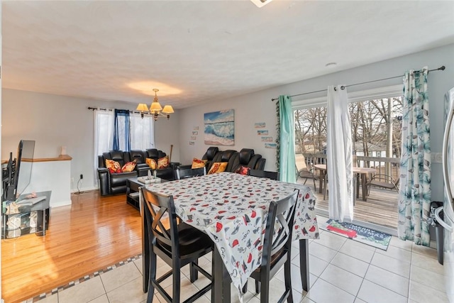 dining room featuring a chandelier and light tile patterned floors