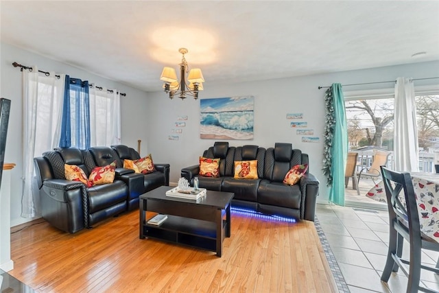 living area with light wood-style floors and a chandelier