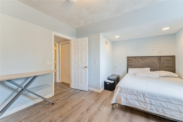 bedroom with recessed lighting, light wood-type flooring, visible vents, and baseboards