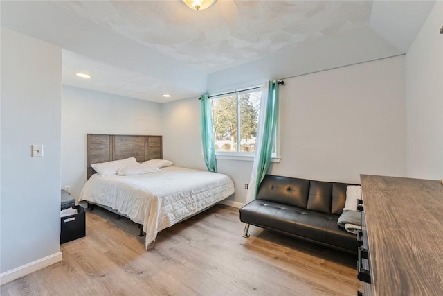 bedroom with recessed lighting, baseboards, and wood finished floors