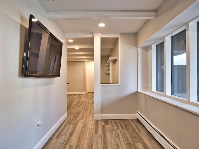 hallway with recessed lighting, a baseboard radiator, wood finished floors, and baseboards