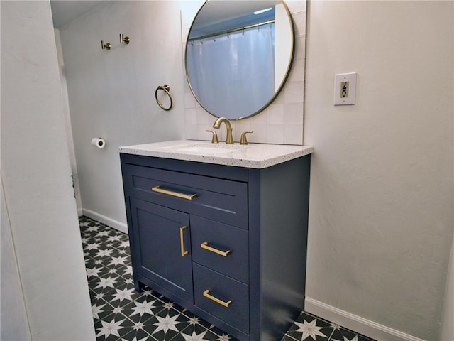 bathroom featuring baseboards, vanity, and tile patterned floors