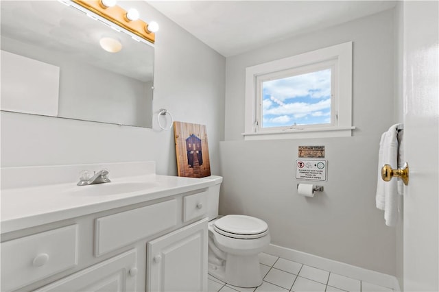 bathroom featuring tile patterned flooring, baseboards, vanity, and toilet