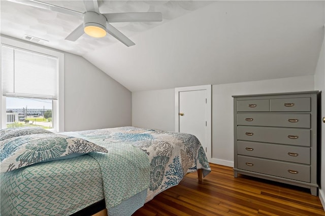 bedroom with vaulted ceiling, ceiling fan, wood finished floors, and visible vents