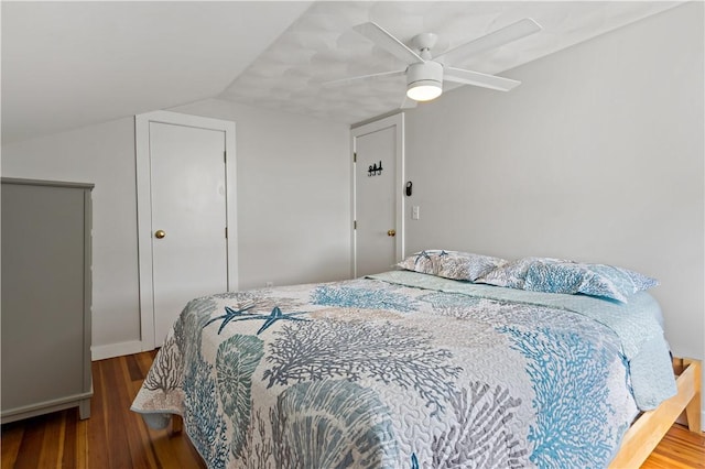 bedroom featuring ceiling fan, vaulted ceiling, and wood finished floors