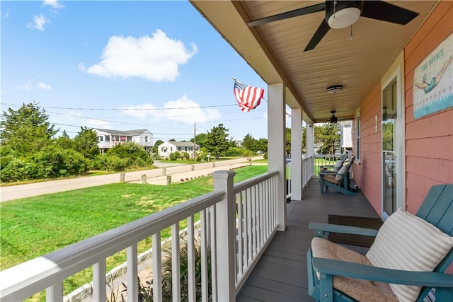 balcony with a porch and ceiling fan