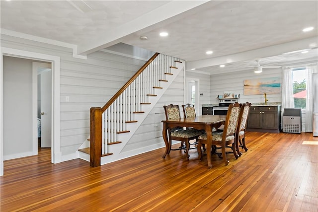 dining space with light wood finished floors, stairway, beam ceiling, and recessed lighting