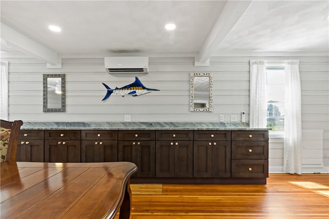 bar featuring beamed ceiling, a wall unit AC, light wood-style flooring, and recessed lighting