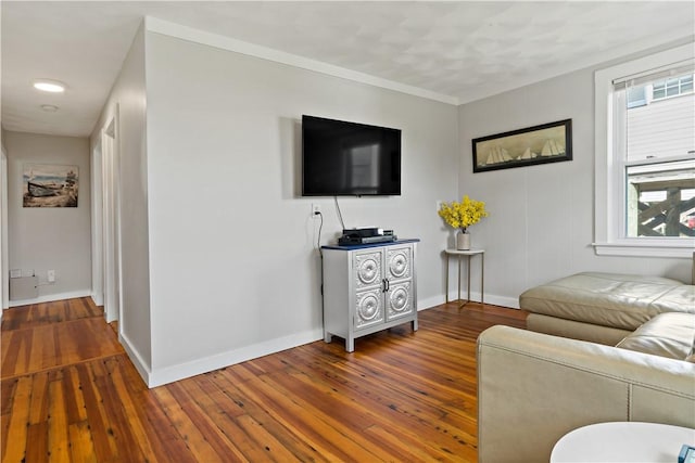 living area featuring wood-type flooring and baseboards