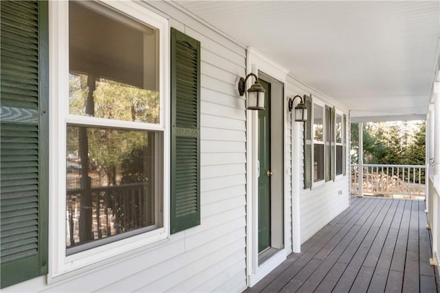 wooden terrace featuring covered porch