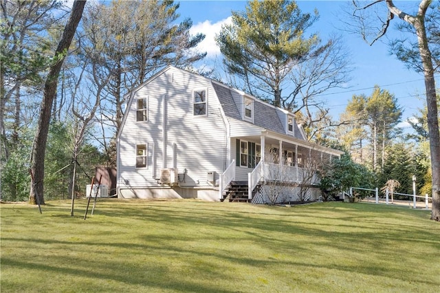 view of home's exterior featuring a yard, roof with shingles, a sunroom, and a gambrel roof