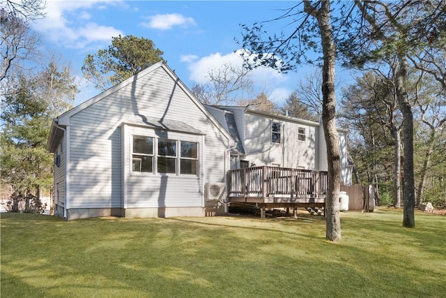 rear view of house featuring a deck and a yard