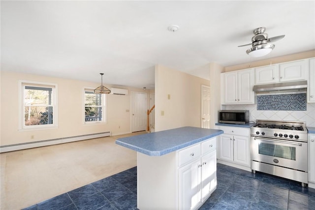 kitchen with tasteful backsplash, baseboard heating, a wall mounted AC, appliances with stainless steel finishes, and under cabinet range hood