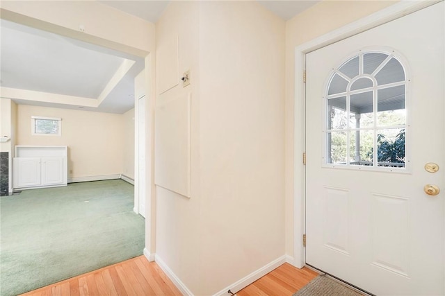 foyer featuring light wood-style flooring and baseboards