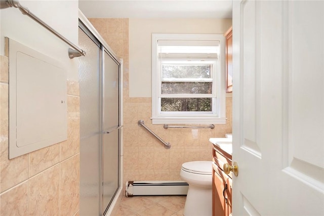 full bath featuring a baseboard radiator, vanity, tile walls, and a shower stall