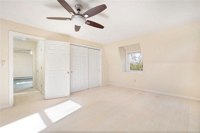 unfurnished bedroom with a ceiling fan, baseboards, baseboard heating, and a closet