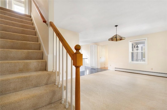 stairs featuring carpet and baseboard heating