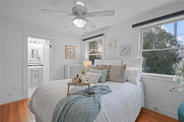 bedroom featuring multiple windows, visible vents, and wood finished floors