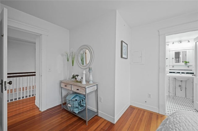 hallway with baseboards and wood finished floors