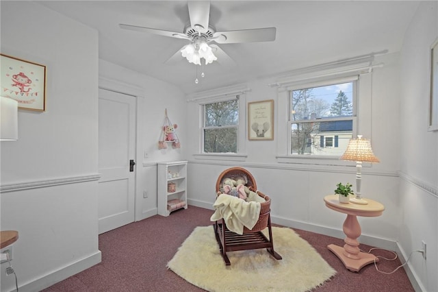 game room featuring ceiling fan, dark carpet, and baseboards