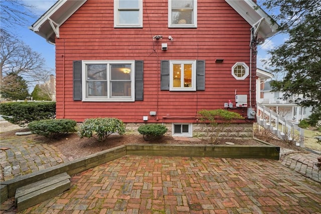 view of side of home with a patio area