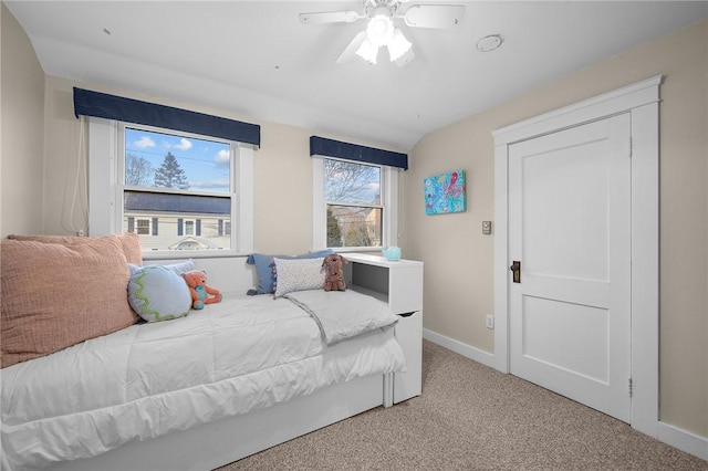 carpeted bedroom featuring a ceiling fan and baseboards