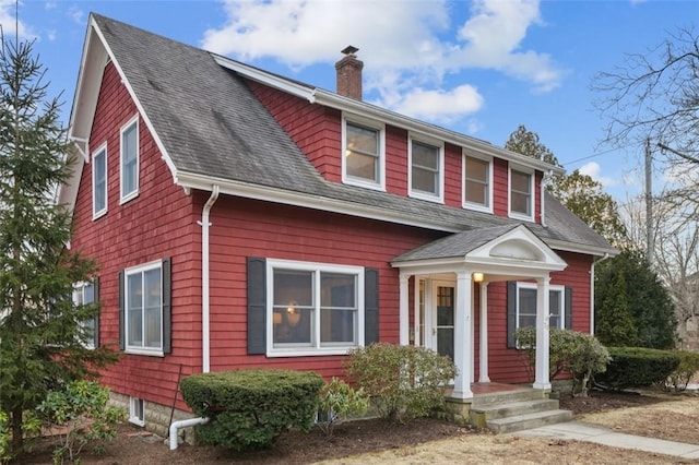 view of front of property with a chimney and roof with shingles