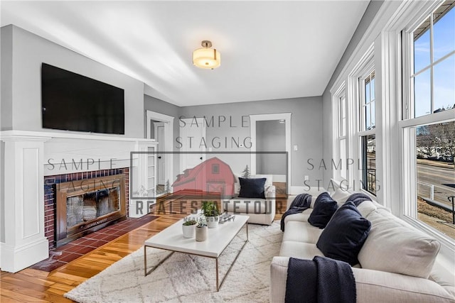 living area with wood finished floors and a tile fireplace