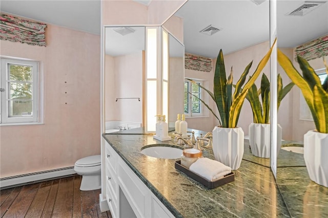 full bath featuring a baseboard radiator, visible vents, wood-type flooring, and vanity