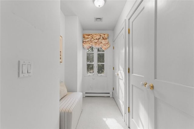 entryway featuring a baseboard radiator, visible vents, and light colored carpet