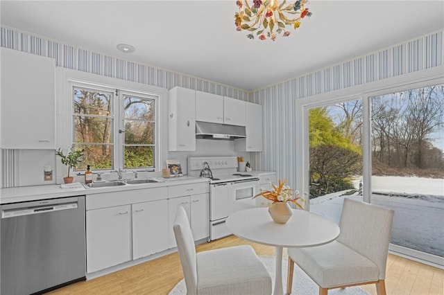 kitchen featuring dishwasher, electric stove, a sink, and wallpapered walls