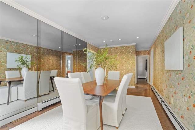 dining area featuring wallpapered walls, ornamental molding, baseboard heating, and wood finished floors