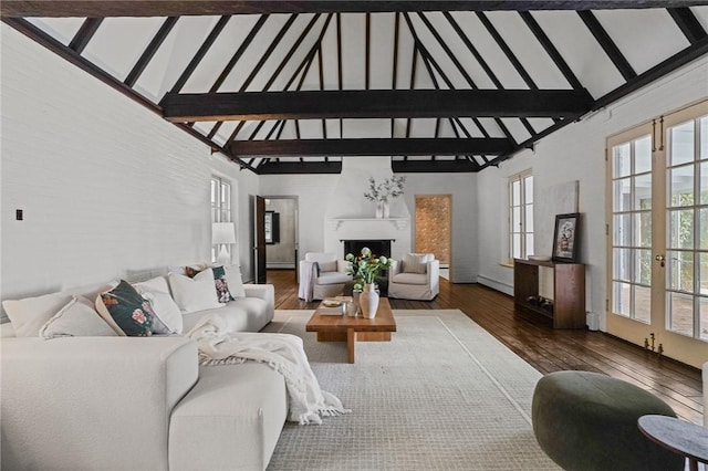 living room featuring beam ceiling, french doors, a fireplace, baseboard heating, and hardwood / wood-style floors