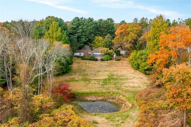 birds eye view of property featuring a view of trees