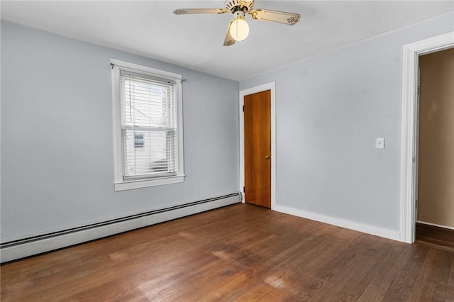 unfurnished room featuring ceiling fan, baseboard heating, wood finished floors, and baseboards