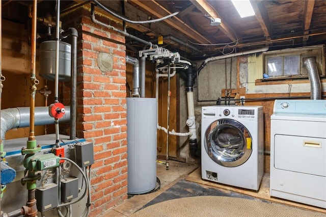 washroom with laundry area, water heater, and washing machine and clothes dryer