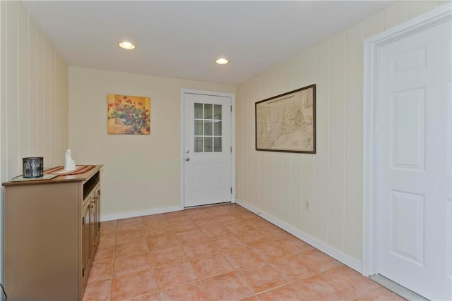 doorway to outside featuring light tile patterned floors, baseboards, and recessed lighting