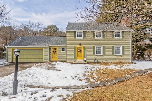 view of front of house featuring roof with shingles, driveway, a chimney, and an attached garage