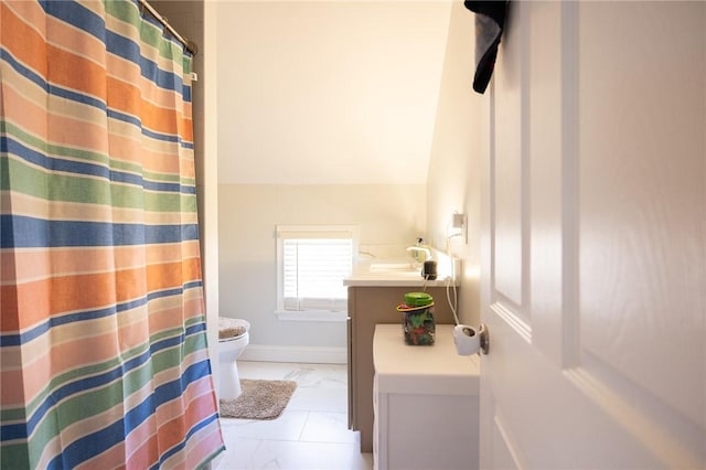 full bathroom with marble finish floor, curtained shower, toilet, vanity, and baseboards