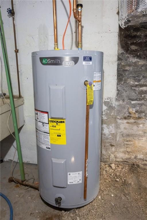 utility room featuring water heater