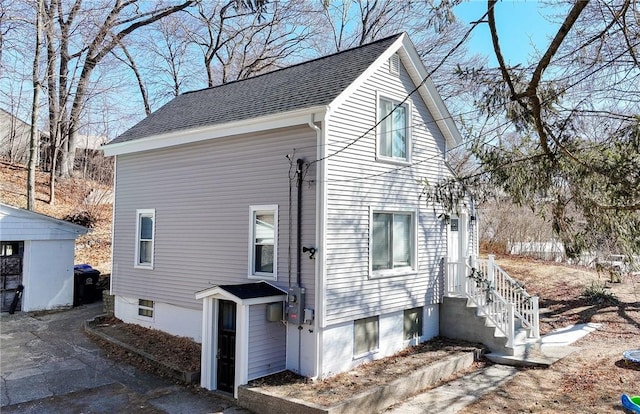 view of front of property featuring roof with shingles