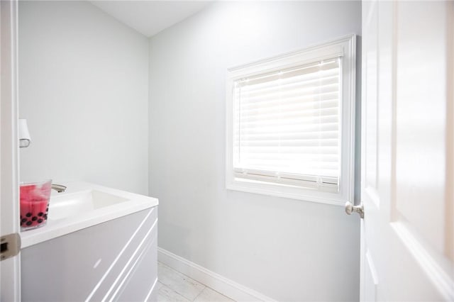 bathroom with vanity and baseboards