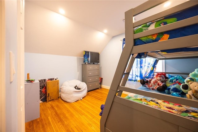 bedroom featuring lofted ceiling and wood finished floors