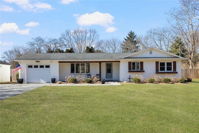 ranch-style home with a garage, a front yard, driveway, and fence