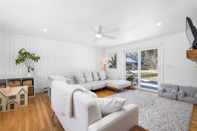 living room featuring a ceiling fan, recessed lighting, light wood-style flooring, and baseboard heating