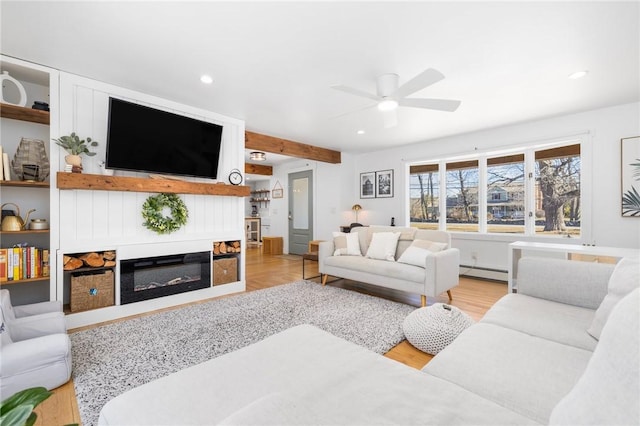 living room with a glass covered fireplace, light wood-style flooring, ceiling fan, a baseboard heating unit, and recessed lighting